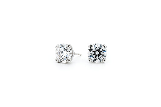 Double claw solitaire earrings RD 0.54 D VS1 IGI in white gold